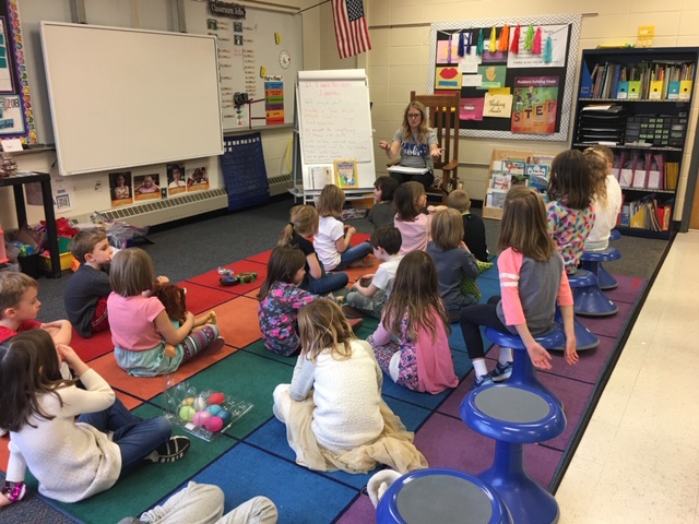 classroom students seated on the floor